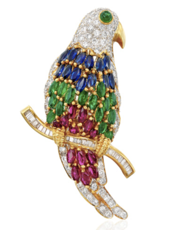 Parrot brooch with diamonds, emeralds, sapphires and baguette diamonds perching on twig