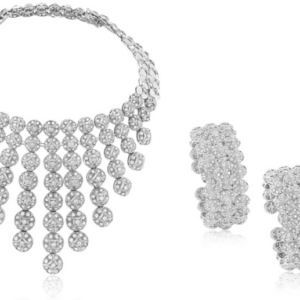 Elegant suite of diamond jewelry in a circular and star shaped motif comprised of a necklace which can be converted to a choker and two cuff bracelets in 18k white gold