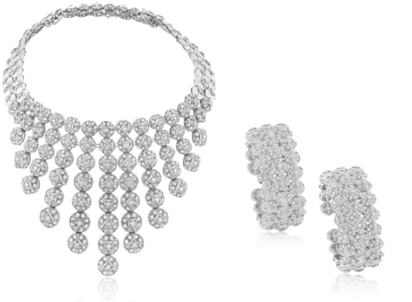 Elegant suite of diamond jewelry in a circular and star shaped motif comprised of a necklace which can be converted to a choker and two cuff bracelets in 18k white gold