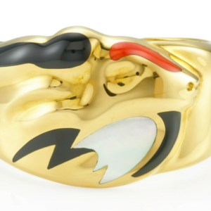 Elsa Peretti for Tiffany: A hinged cuff of the Zodiac symbol for Capricorn of a goats head and fish tail in 18k yellow gold, coral, black jade, and mother of pearl